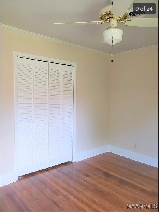 unfurnished bedroom featuring a closet, ceiling fan, hardwood / wood-style floors, and crown molding