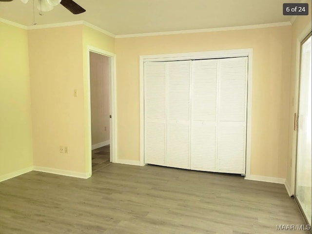 unfurnished bedroom with ceiling fan, ornamental molding, and hardwood / wood-style floors