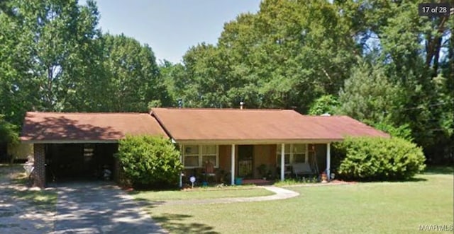 ranch-style home featuring a garage and a front lawn