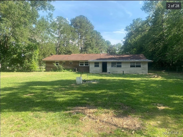 rear view of house with a yard