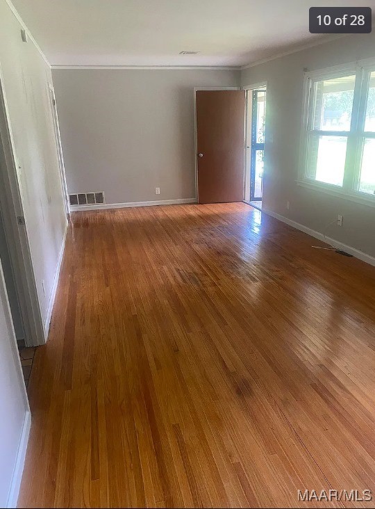 spare room featuring ornamental molding and wood-type flooring