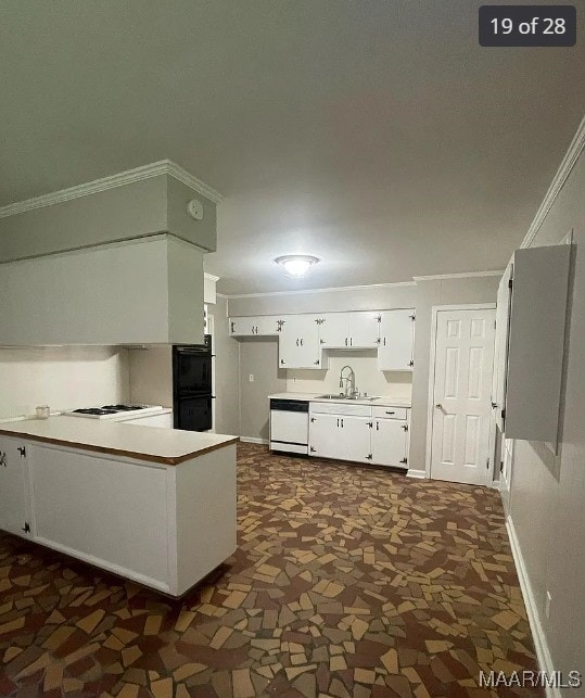 kitchen featuring white cabinetry, white appliances, kitchen peninsula, ornamental molding, and sink