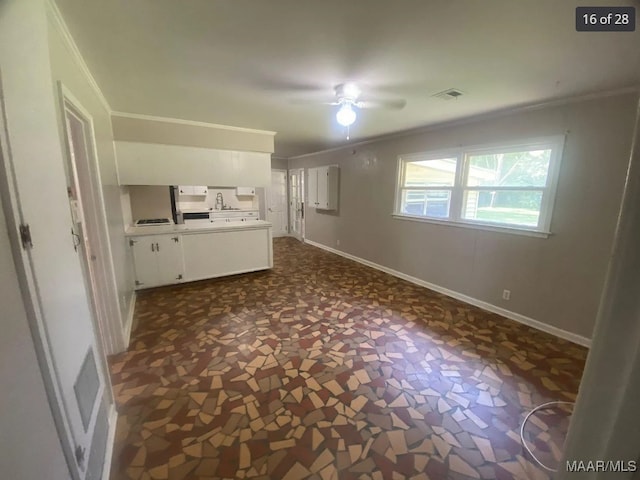 kitchen with ornamental molding, white cabinets, and ceiling fan