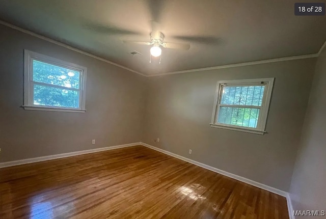 empty room with wood-type flooring, ceiling fan, and crown molding