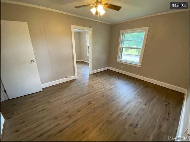 empty room featuring crown molding, dark hardwood / wood-style floors, and ceiling fan