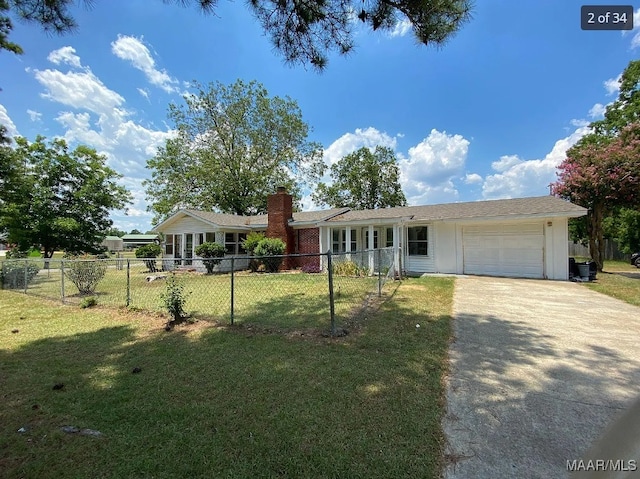 single story home featuring a garage and a front lawn