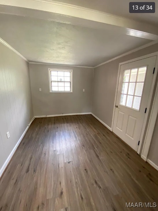 unfurnished room featuring crown molding and dark hardwood / wood-style flooring