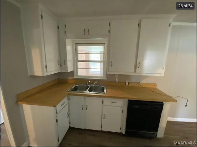 kitchen with black dishwasher, dark hardwood / wood-style floors, sink, and white cabinetry