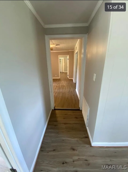 hall featuring crown molding and dark hardwood / wood-style floors