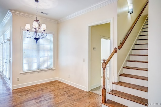 interior space featuring ornamental molding, hardwood / wood-style floors, and a notable chandelier