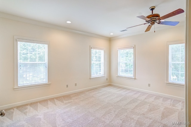 carpeted empty room featuring crown molding and ceiling fan