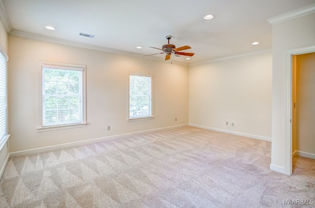 unfurnished room with ornamental molding, light colored carpet, plenty of natural light, and ceiling fan