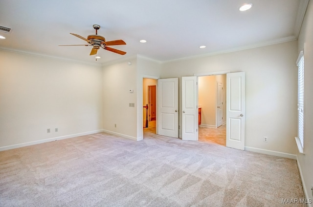 unfurnished bedroom featuring ceiling fan, light carpet, and ornamental molding