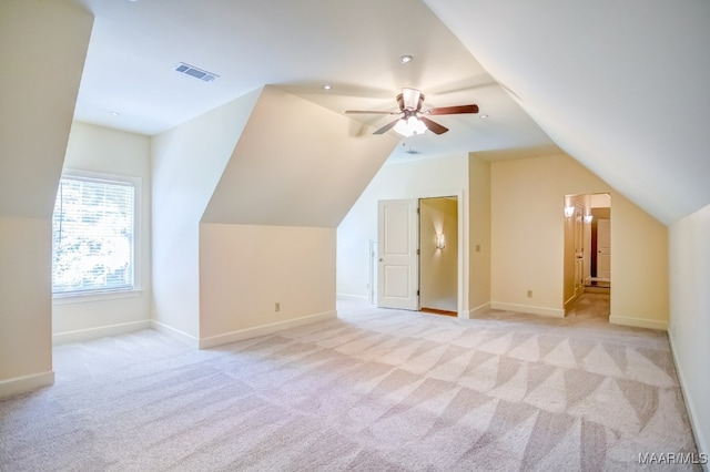 bonus room with vaulted ceiling, light colored carpet, and ceiling fan