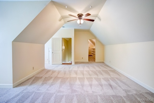 bonus room with light carpet, vaulted ceiling, and ceiling fan