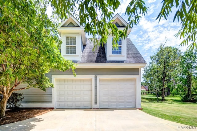 view of front of house with a garage and a front yard