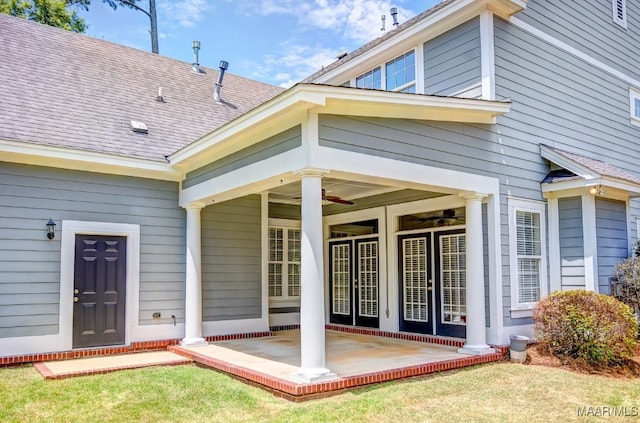 rear view of property with a yard, ceiling fan, and a patio area