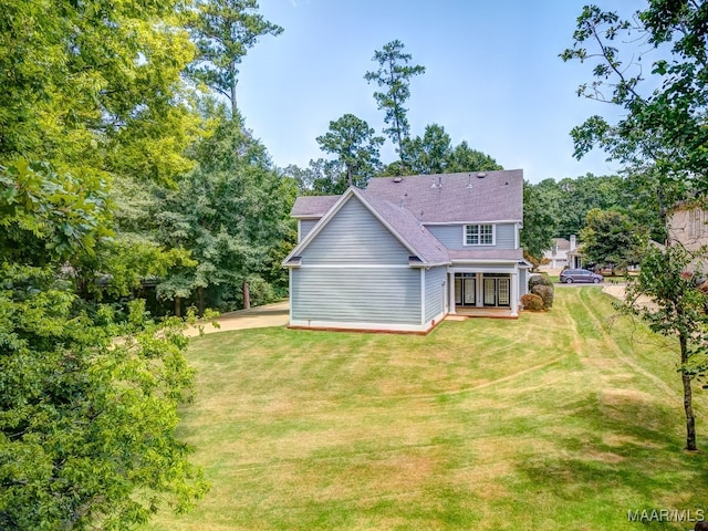 rear view of house with a lawn