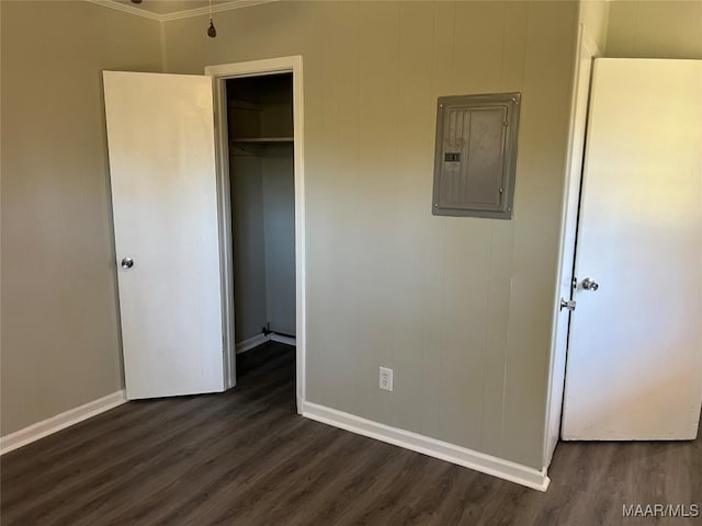 unfurnished bedroom with dark hardwood / wood-style floors, electric panel, and a closet