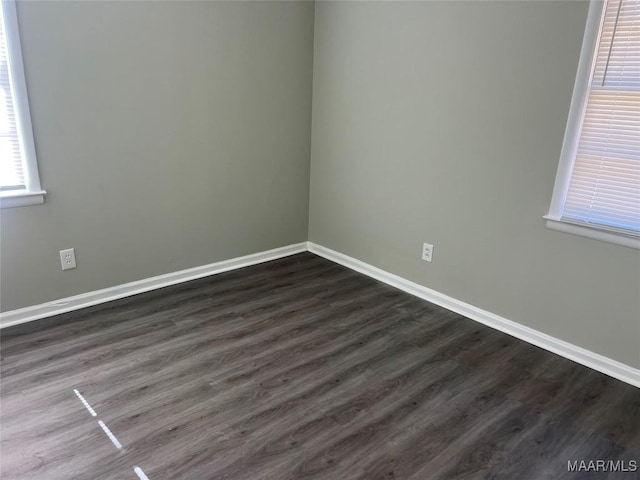 empty room with dark hardwood / wood-style floors