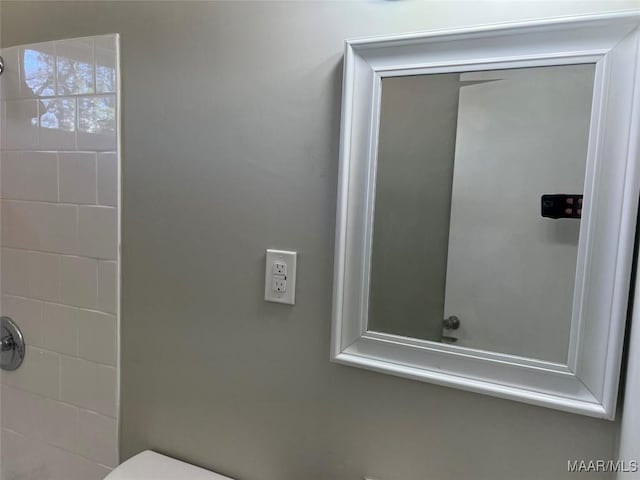 bathroom with a tile shower