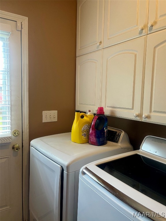 laundry area with cabinets and washing machine and dryer