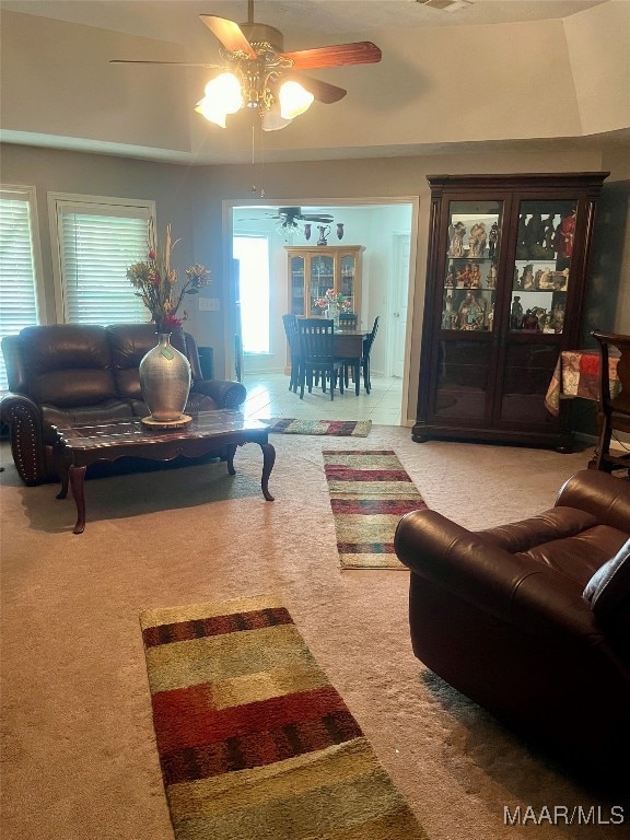 living room featuring carpet flooring and ceiling fan