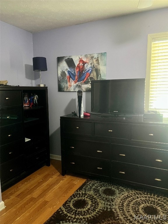 bedroom featuring a textured ceiling and hardwood / wood-style floors