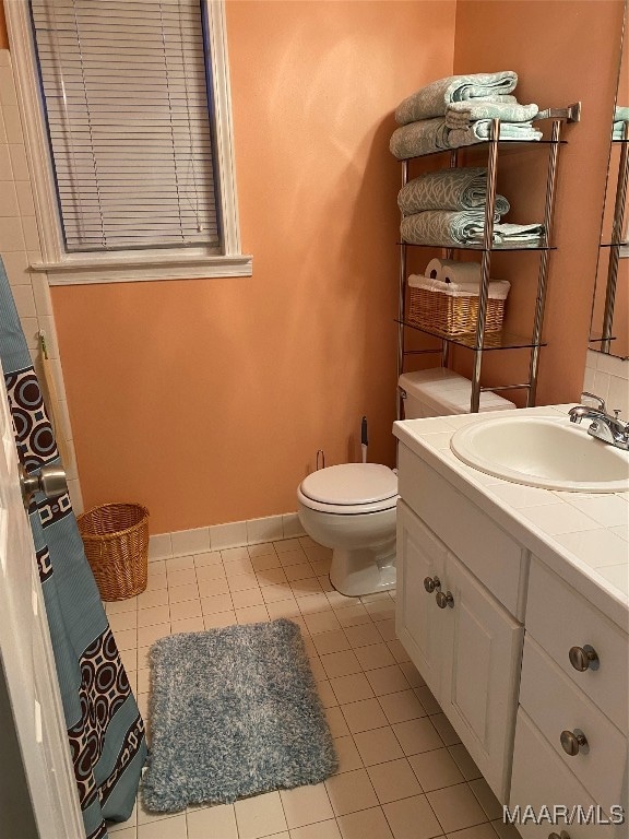 bathroom with tile patterned flooring, toilet, and vanity