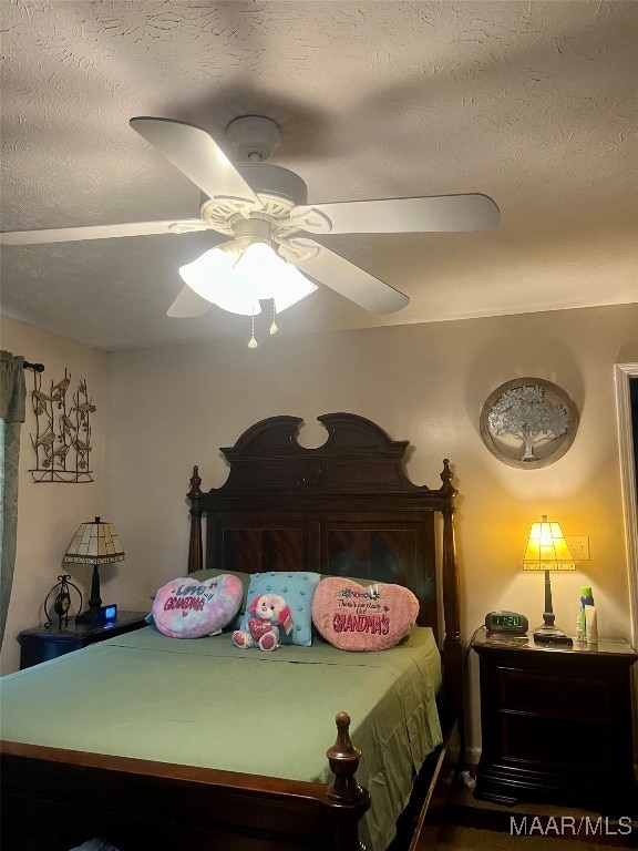 bedroom with a textured ceiling and ceiling fan