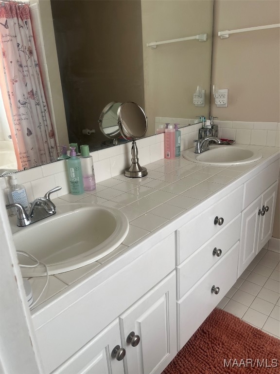 bathroom with tile patterned floors, a shower with shower curtain, and vanity