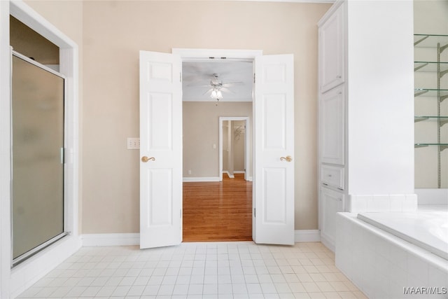 bathroom with tile patterned flooring, ceiling fan, and plus walk in shower