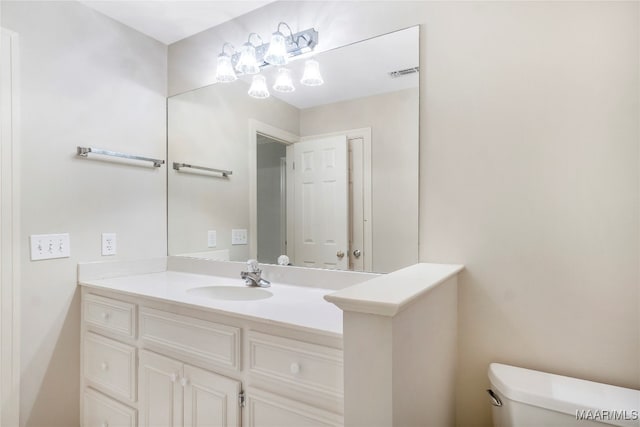 bathroom featuring vanity and toilet