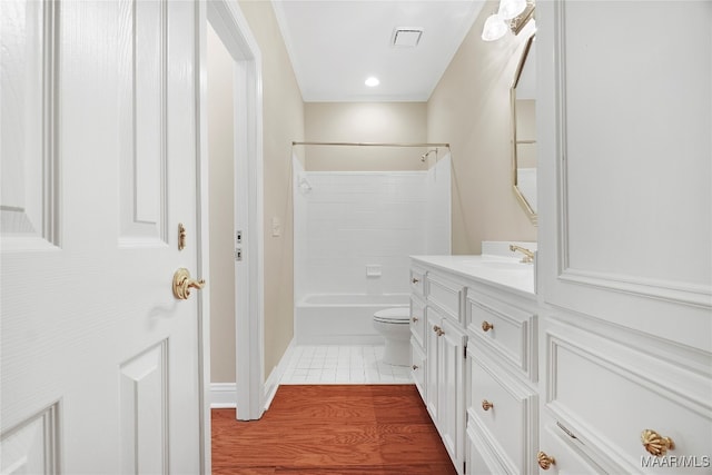 full bathroom featuring vanity, toilet, wood-type flooring, and shower / bath combination