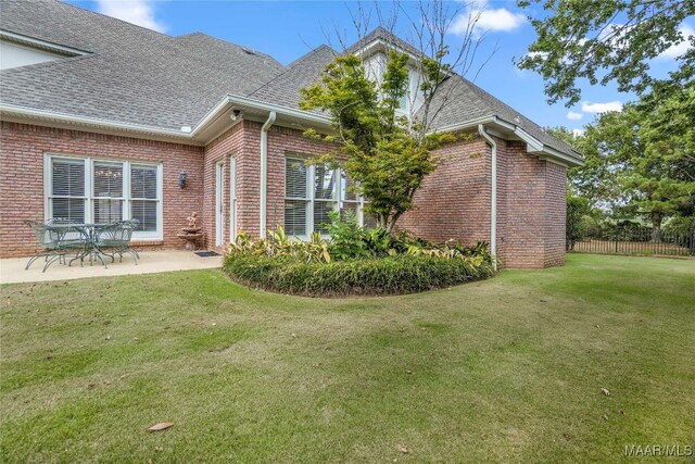 rear view of house with a patio area and a yard