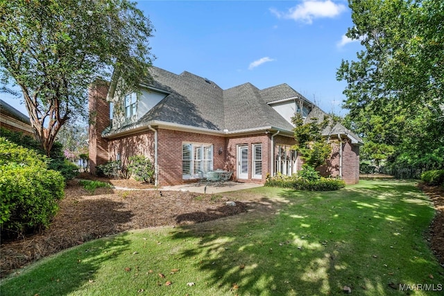 view of side of property with a lawn and a patio