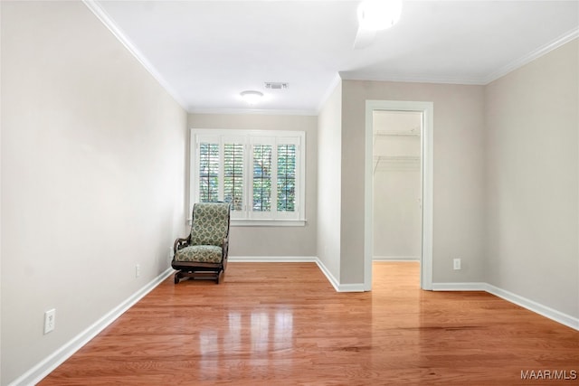 unfurnished room featuring ornamental molding, light hardwood / wood-style flooring, and ceiling fan