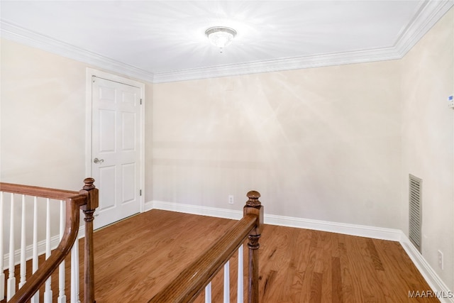 interior space featuring crown molding and hardwood / wood-style flooring