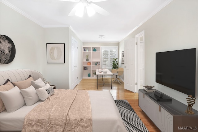 bedroom featuring light wood-type flooring, ornamental molding, and ceiling fan