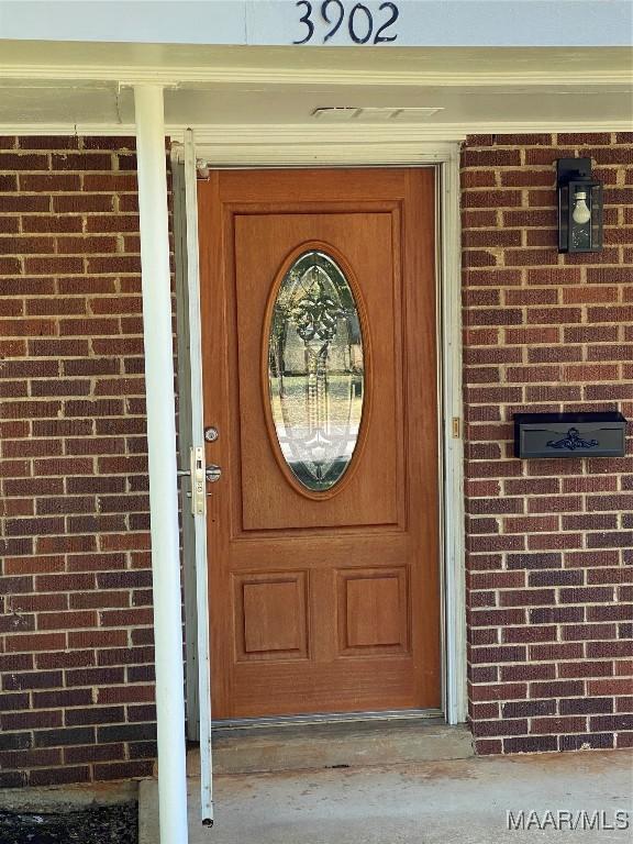 entrance to property with brick siding