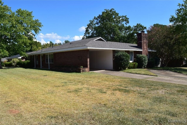 view of front of house with a chimney, a front lawn, aphalt driveway, and a carport