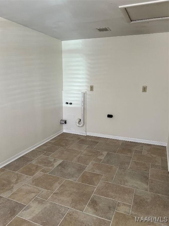 washroom featuring baseboards and visible vents