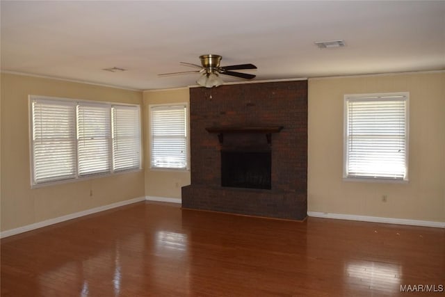unfurnished living room featuring wood finished floors, baseboards, a ceiling fan, and visible vents