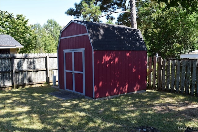 view of outbuilding featuring a lawn