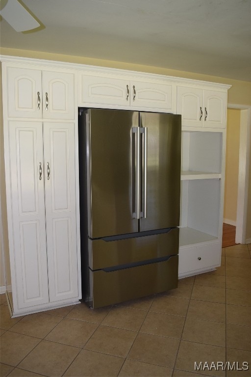 kitchen featuring white cabinets, tile patterned flooring, and high quality fridge