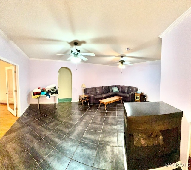 tiled living room with crown molding and ceiling fan