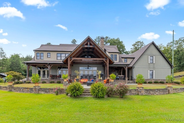 rear view of house with a yard, a chimney, an outdoor hangout area, a patio area, and ceiling fan