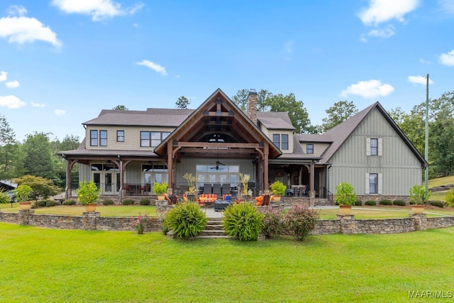 1111 County Road 546, Verbena, AL 36091 - rear view of house featuring a ceiling fan, a yard, a chimney, board and batten siding, and outdoor lounge area