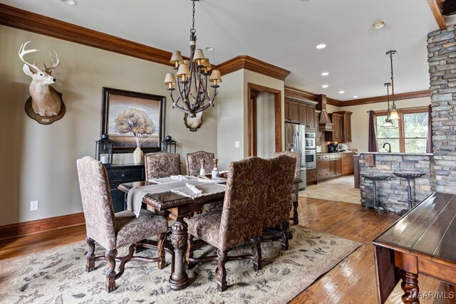 dining area featuring recessed lighting, light wood-style floors, and crown molding