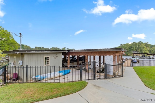 view of front of home with a water view, fence, and a front yard